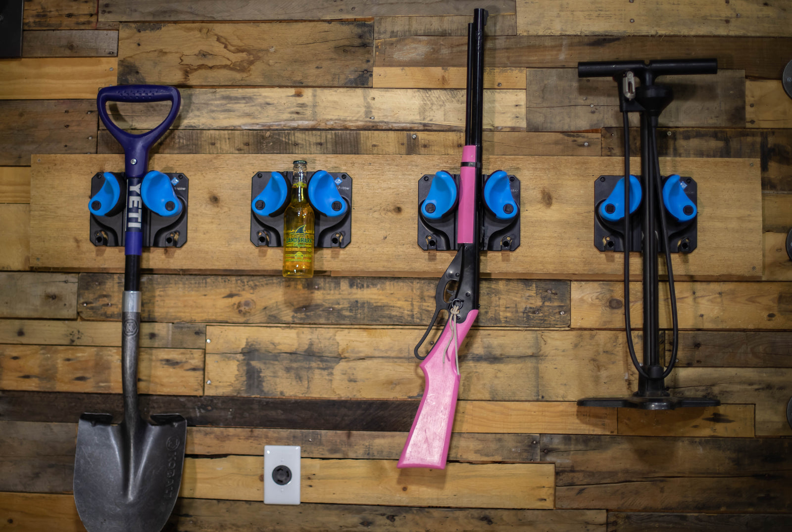 4 Gravity Grabbers, a storage solution, hold a shovel, and beer, an unloaded BB gun, and a bike pump. 